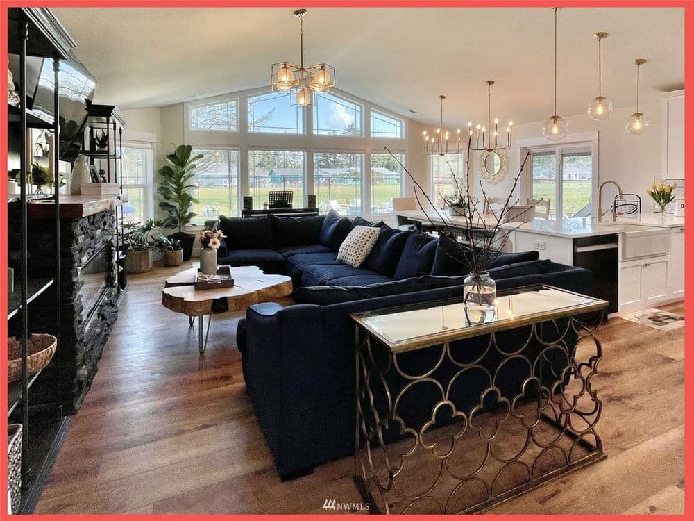 Spacious living room with modern furnishings, large windows, and contemporary decor.